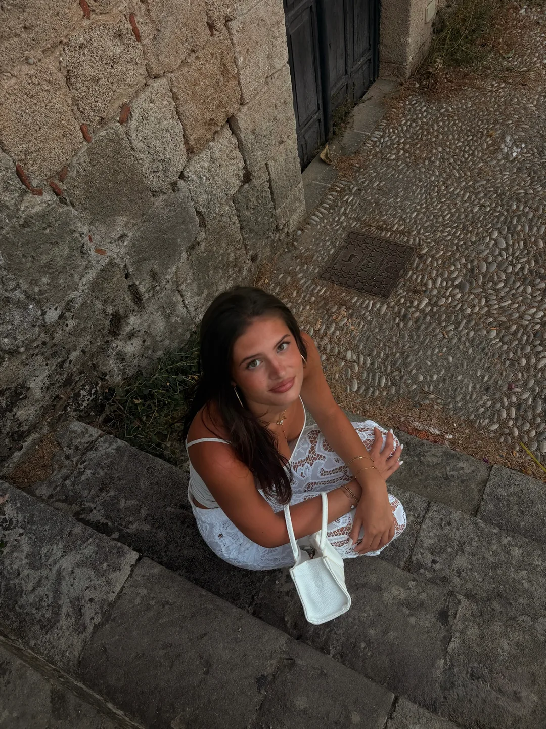 Woman sitting on ancient stone steps